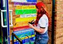 Artist Becca Smith hand paints a colourful mural of children's favourite books at Mobberley Primary School