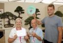 Frances Feldwick, treasurer, Gerald Sutton, chairman, and Matt Wood, membership secretary, celebrate after Cheshire Bonsai Society wins a gold medal and best exhibit in the flower marquee at RHS Tatton Flower Show