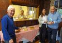 Barry Wienholdt, right, co-author of the original publication and creator of the new book enjoys tea and cakes with volunteers