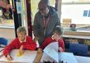 Kenyan teacher Thomas Guto  working with pupils at Egerton Primary School