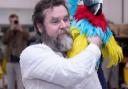 Michael Gallagher as Long John Silver with a parrot