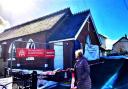 The new Goostrey Post Office takes shape at the Methodist church as visitor Pauline Harkinson looks on