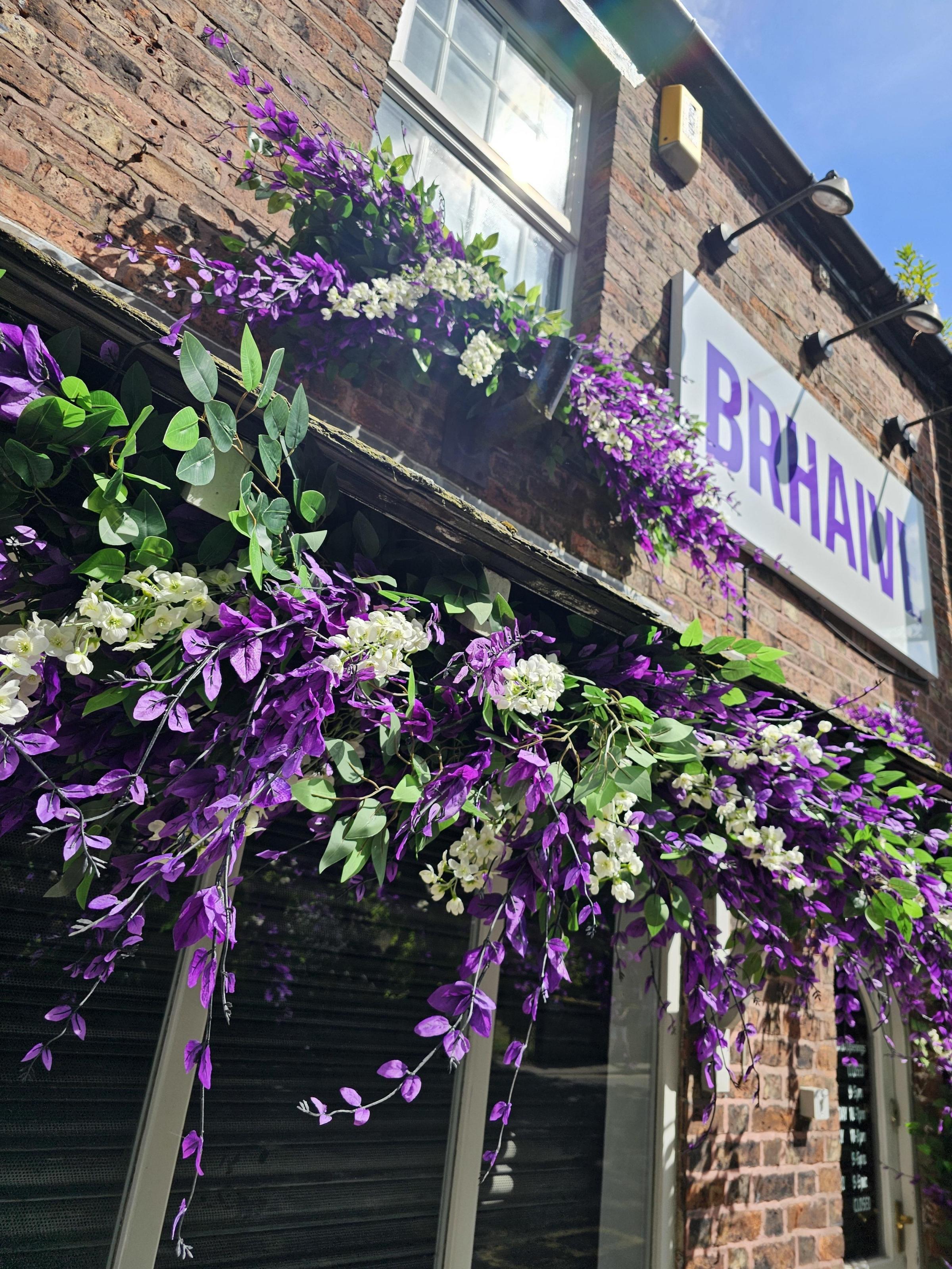 Purple and white wisteria adorn the shop front