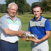 Sam Johnson receives the Hunter Trophy from Wilmslow GC vice-captain Berkeley Thirsk