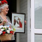 Liz Scott holding a picture of the day she was crowned May Day queen Pictures: Sarah King