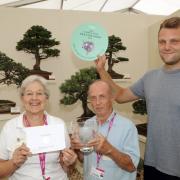 Frances Feldwick, treasurer, Gerald Sutton, chairman, and Matt Wood, membership secretary, celebrate after Cheshire Bonsai Society wins a gold medal and best exhibit in the flower marquee at RHS Tatton Flower Show