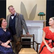 From left, actors Victoria Johnson (Veta Louise Simmons), Ian Tyler (Elwood P Dowd) and Scarlet Newton (Myrtle Mae) gazing at an empty seat occupied by the invisible Harvey