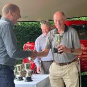 Richard Okill receives a trophy for winning the Premier Berry at Over Peover Gooseberry Show