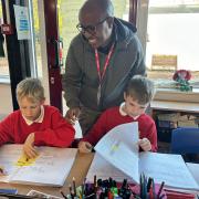 Kenyan teacher Thomas Guto  working with pupils at Egerton Primary School