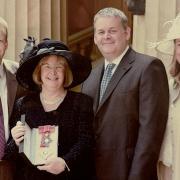 Sandra outside Buckingham Palace after being made a Dame in the New Year Honours in 2004, with her family, from left, Matthew, Eliot and Victoria