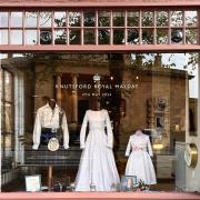 Knutsford Royal May Day costumes on display in the shop window of Arthur Lee Interiors