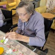 A lady enjoys painting  as residents create their own sea mural