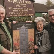 David Clarke and Bernard Tuck present the commemorative artwork to Anne Venables, deputy church warden at St Peter’s Church, in Lower Withington