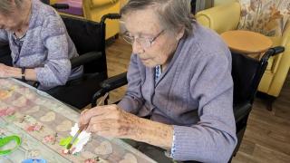A lady enjoys painting  as residents create their own sea mural