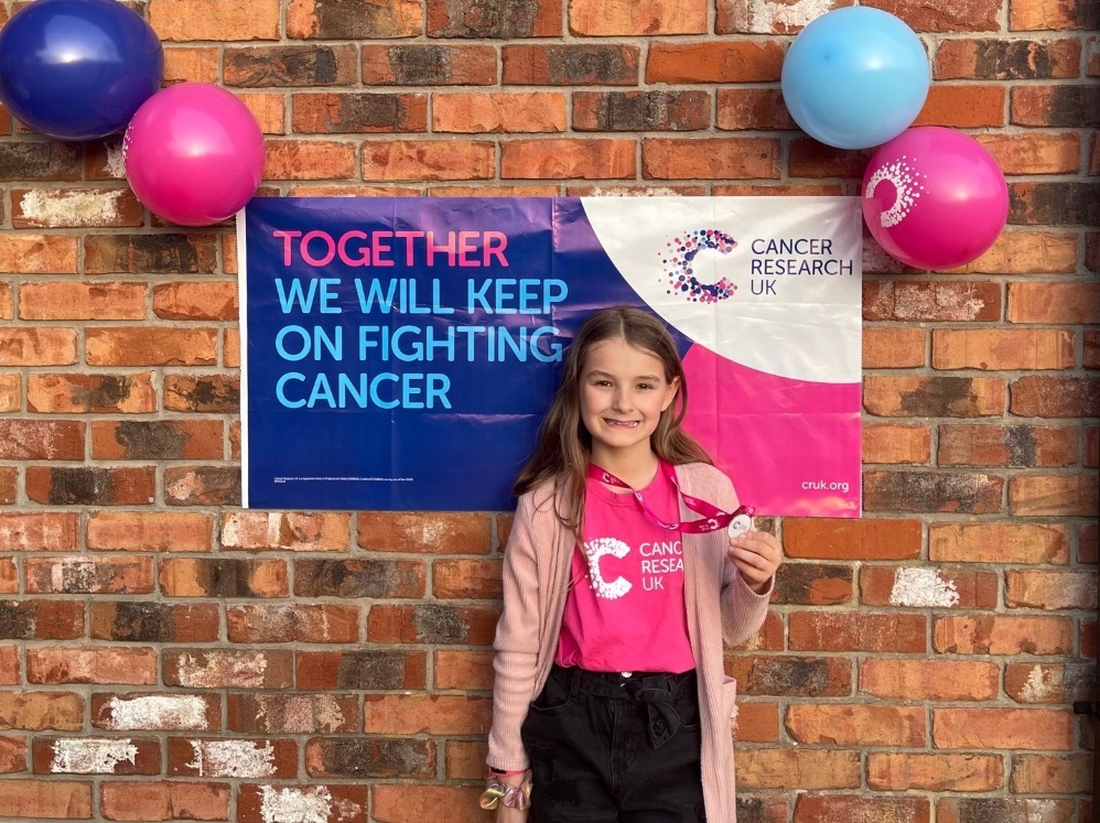 Charley received a medal from Cancer Research UK for her incredible achievement
