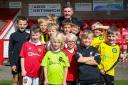 FOOTBALL: Juniors from Egerton Football Club had a great day out when they paid a debut visit to Northern Premier League West club Witton Albion earlier this season to watch them play against Mossley. Here, the youngsters, ranging from under sevens to
