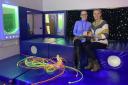 Teleri Pitts, special educational needs co-ordinator, and Catherine Dooley, specialist resource provison, celebrate the sensory room's first anniversary with a birthday cake