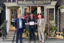Deputy mayor Cllr Colin Banks, Morgan Ward and Sam Youd outside Morgan Edwards, winner of the RHS Best Dressed Window competition