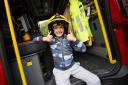 A child having a fabulous time in a fire engine