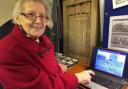 Goostrey's oldest retired shopkeeper and postmistress, Margaret Kettle, who is 99 in November, catching up with the past at a previous archive display Picture: John Williams