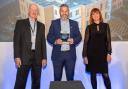 Adam Robertson MTX pre-construction director, centre, receives the national award for modular construction excellence from sponsors