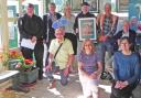Artist Eamonn Murphy, fourth from left rear row, join the team to launch the village art trail at Handforth Station