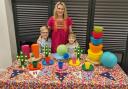 Susan Hancock with sons Teddy and Archie and some of her colourful reusable tableware and decorations