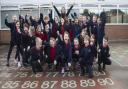 Hannah George, Anwyl regional marketing manager with Hermitage Primary School pupils delighted with their new outdoor lighting