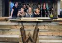 Staff celebrate the opening of a new terrace bar at Wine and Wallop