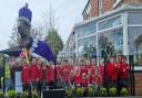 Children from Goostrey Community Primary School crown T-Rex to celebrate the coronation