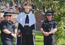 Police officers with a life-sized woollen figure of King Charles