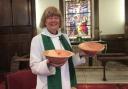 Rev Heather Buckley with an offertory plate and a holy water bowl made by local wood turner David Webb from wood salvaged from a juniper tree taken down in the churchyard