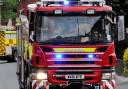 Firefighters rescued a man after a car fell down an embankment into shallow water