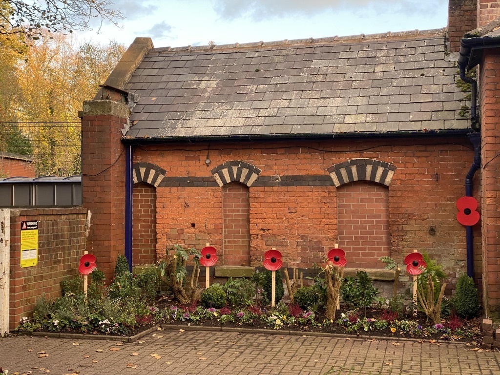 Volunteers have placed poppies in flower beds at Alderley Edge Station