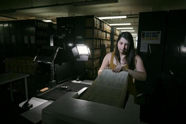 Knutsford Guardian: Photo via PA shows Findmypast technician Laura Gowing scans individual pages of the 30,000 volumes of the 1921 Census at the Office for National Statistics (ONS) near Southampton.
