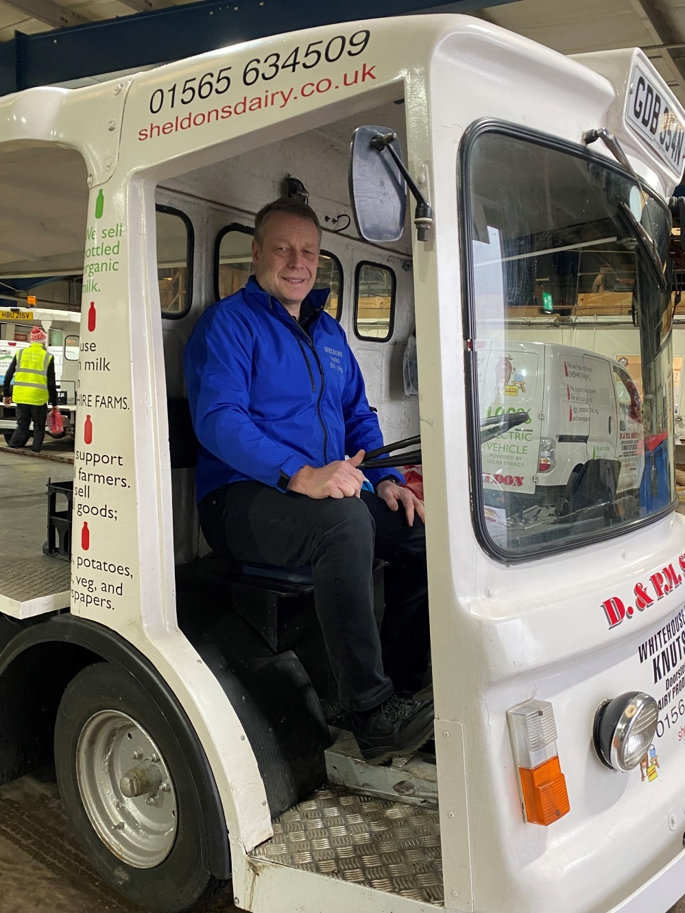 Chris Sheldon on one of the electric milk floats charged by solar panels at the dairy premises