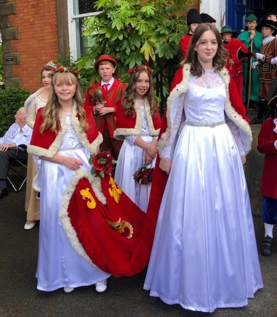 Knutsford Guardian: Cara Chaplin carries the train for Royal May Day Festival Queen Lily-May Newall Picture: Emma Chaplin