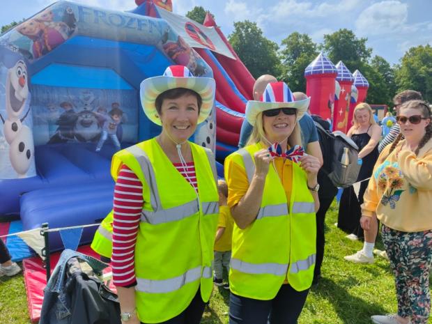 Knutsford Guardian: Knutsford Lions Dee Griffiths and Sarah Flannery help children have fun on a bouncy castle