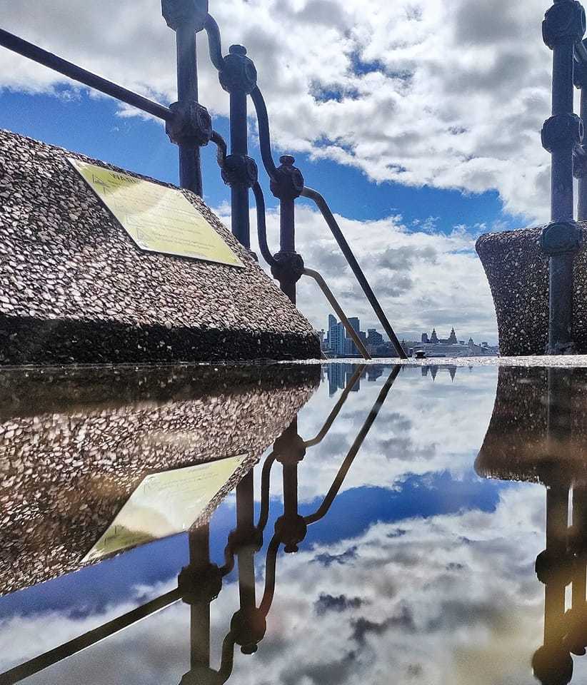 Both sides of the Mersey reflected in one puddle at Egremont Primenade Kimberley Phillips