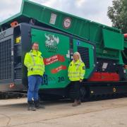 Tom McLaren and Becky Curley celebrating the sale of the 100th Hass Tyron shredding machine
