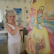 Artist Janice Sylvia Brock with one of her latest paintings
