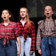 Mae Clark, 12, Sophie Pickup, 16 and Mlllie Thorp, 12, performing a medley from Come From Away in the West End