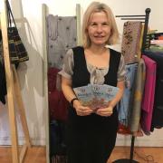 Sandra Curties with the new town shopping map in Blossom Boutique