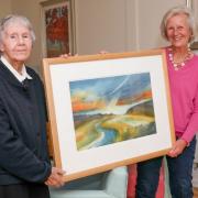 Sisters Jenny Holbrook and Angela Scott with one of her fine art paintings, Mawddach Estuary
