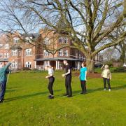 Residents and staff at Cranford Grange care home in Mobberley skipping on the lawn