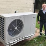 John Hillary beside the big heat pump he has had fittedat the side of his Knutsford home