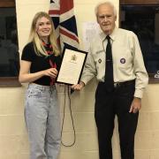 Amber Houghton receives her Queens' Scout Award from Tony Leadbetter, president of Knutsford Scouts