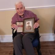 Retired architect John Allcock with a photograph of his war hero brother Alec, shot and killed in the Battle of Monte Cassino