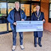Rob Bisset, TEMPO assistant treasurer receives a community grant from Cllr Frank McCarthy, chairman of Wilmslow Town Council
