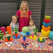 Susan Hancock with sons Teddy and Archie and some of her colourful reusable tableware and decorations